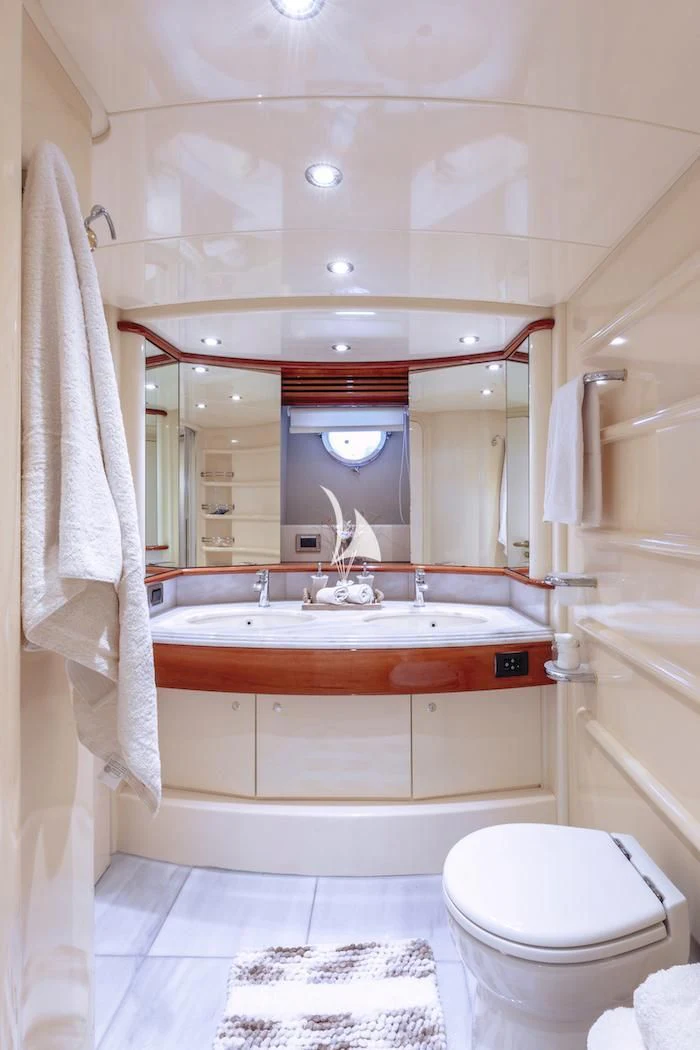 a bathroom with a large mirror aboard MANU Yacht for Charter