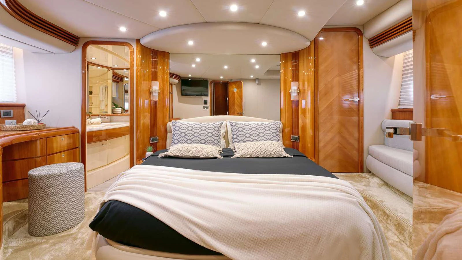 a room with a bed and a mirror aboard MANU Yacht for Charter