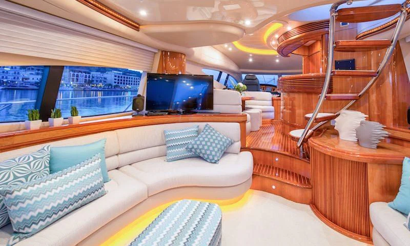 a room with a couch and a tv aboard MANU Yacht for Charter