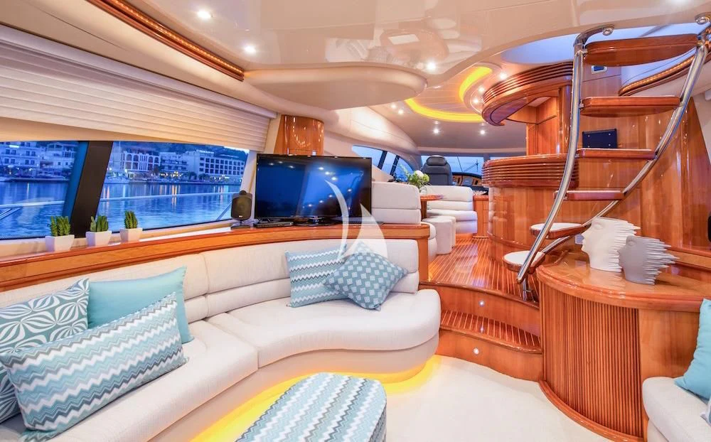 a room with a couch and a tv aboard MANU Yacht for Charter