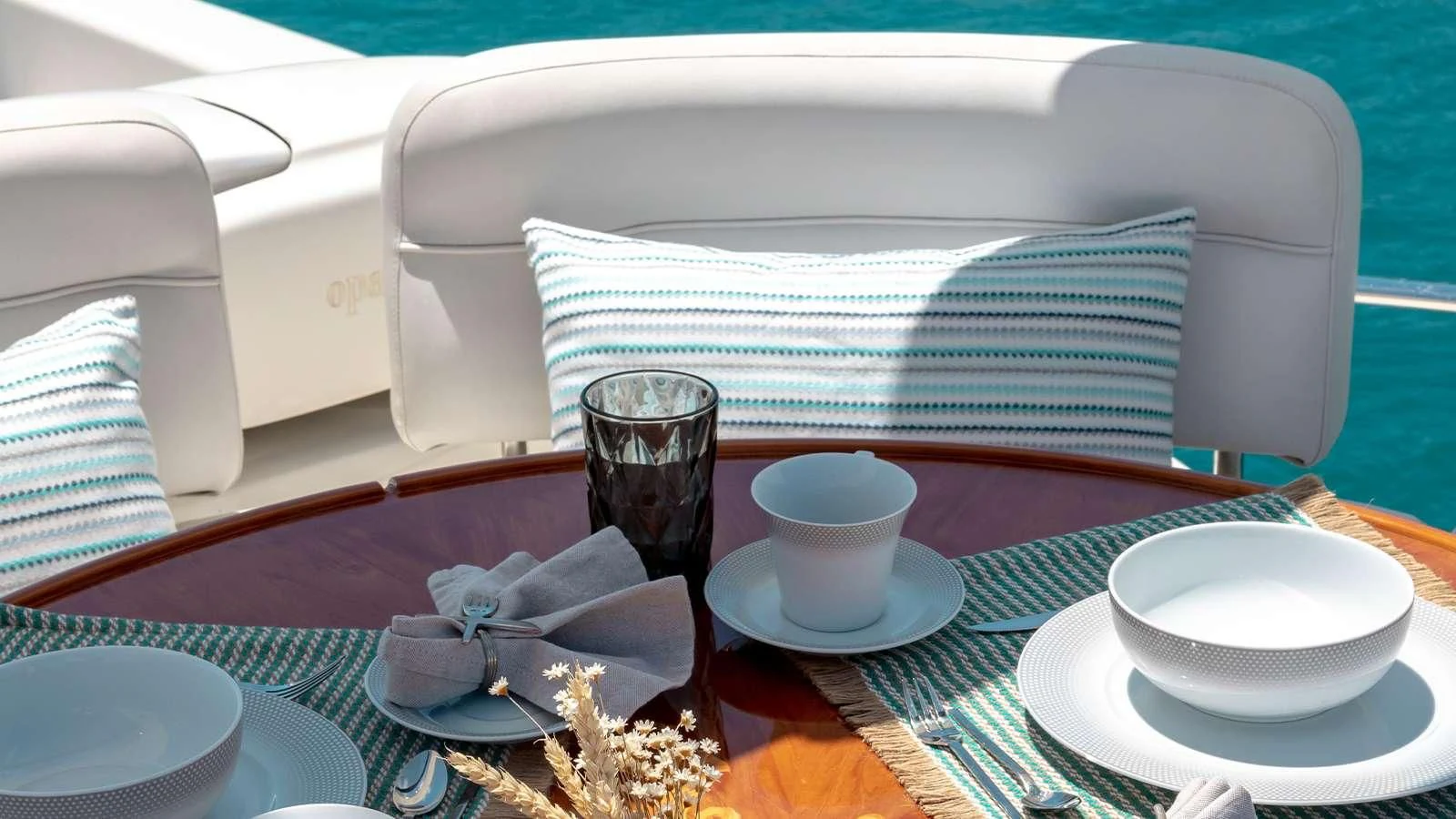 a table with plates and cups on it aboard MANU Yacht for Charter