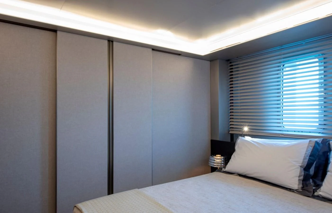 a bed with a white pillow aboard MYKO Yacht for Sale
