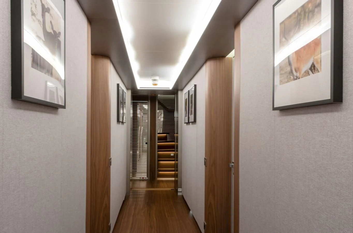 a hallway with a wood floor and a wood door aboard MYKO Yacht for Sale