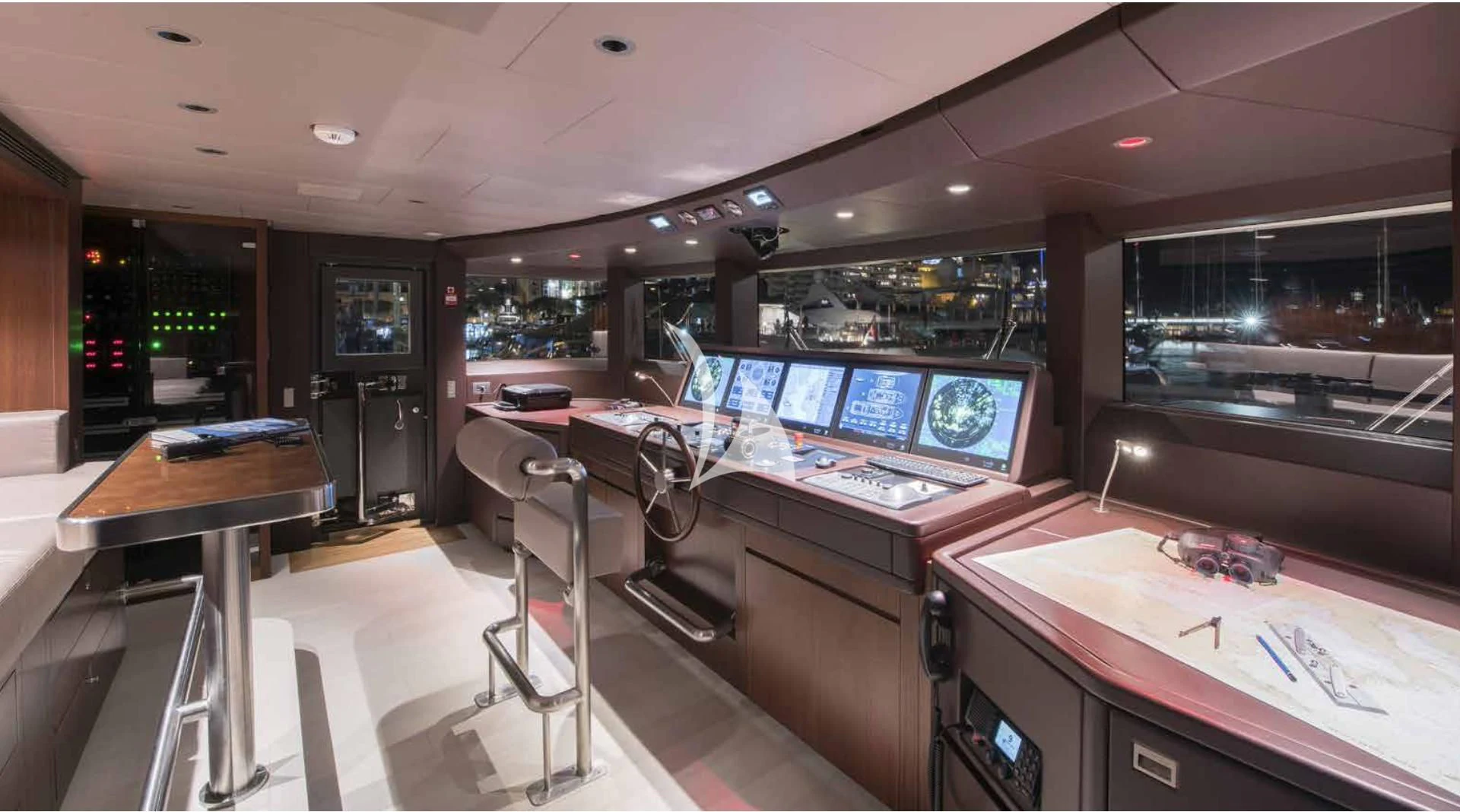 a room with a table and chairs aboard MYKO Yacht for Sale