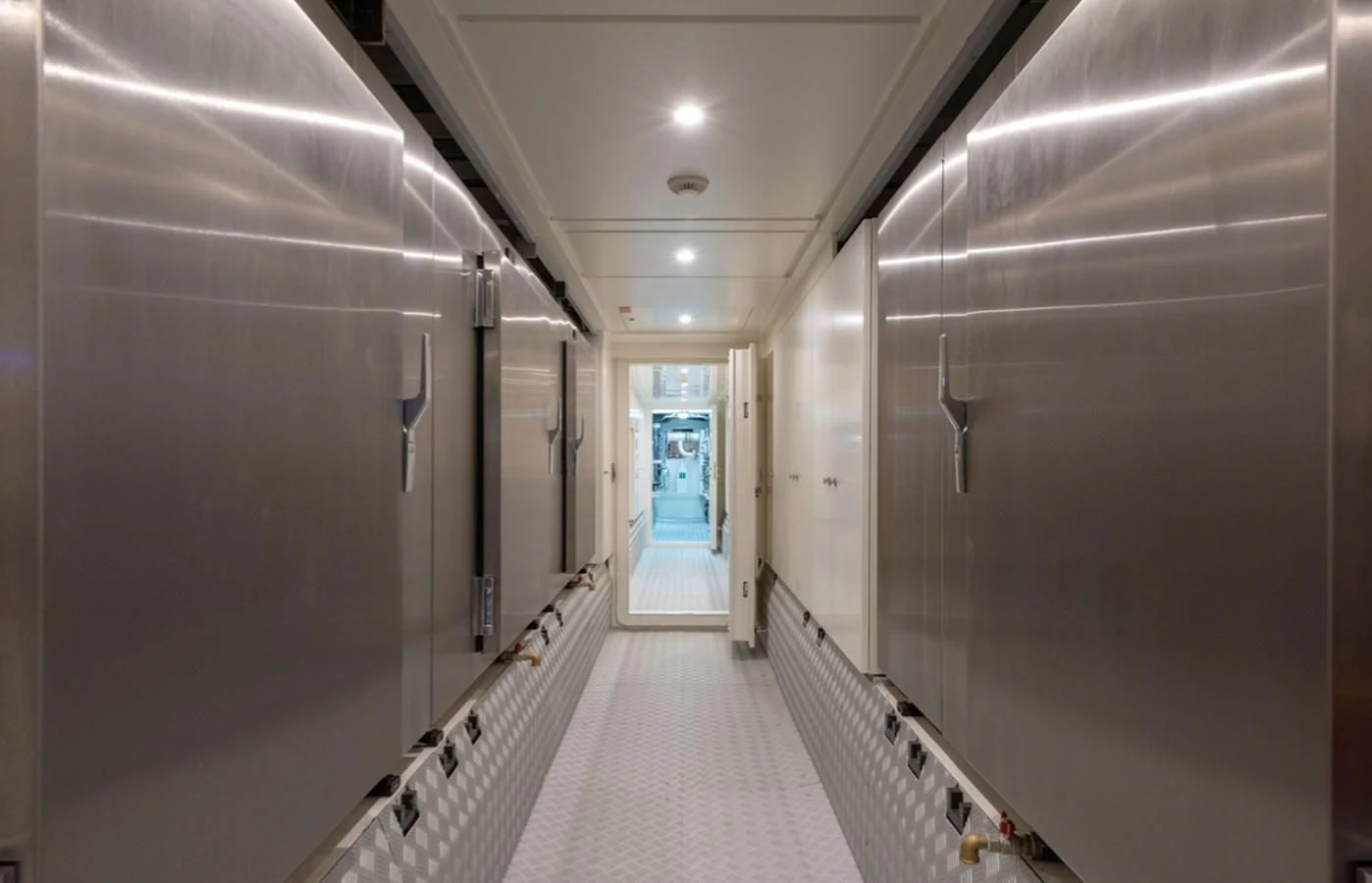 a hallway with a door and a machine on the floor aboard MYKO Yacht for Sale