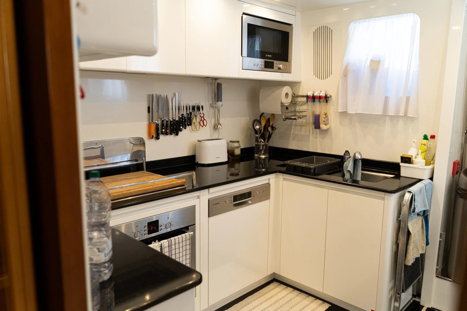 a kitchen with white cabinets aboard ALPINN Yacht for Sale