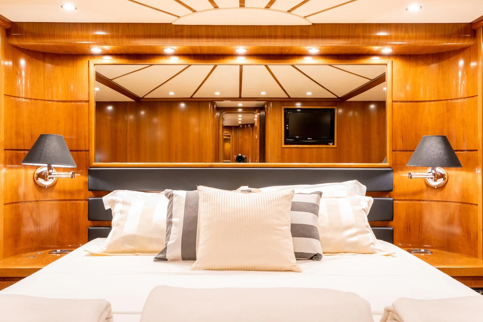 a bed with white sheets and pillows aboard ALPINN Yacht for Sale