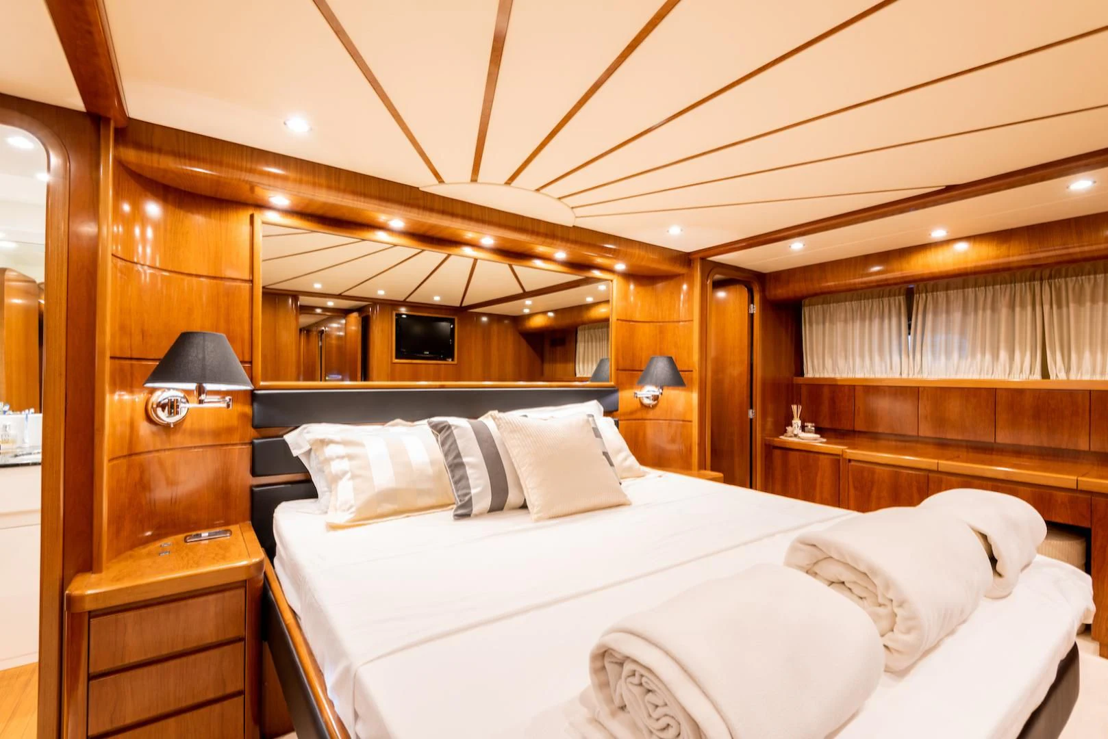 a bed with white sheets and pillows aboard ALPINN Yacht for Sale