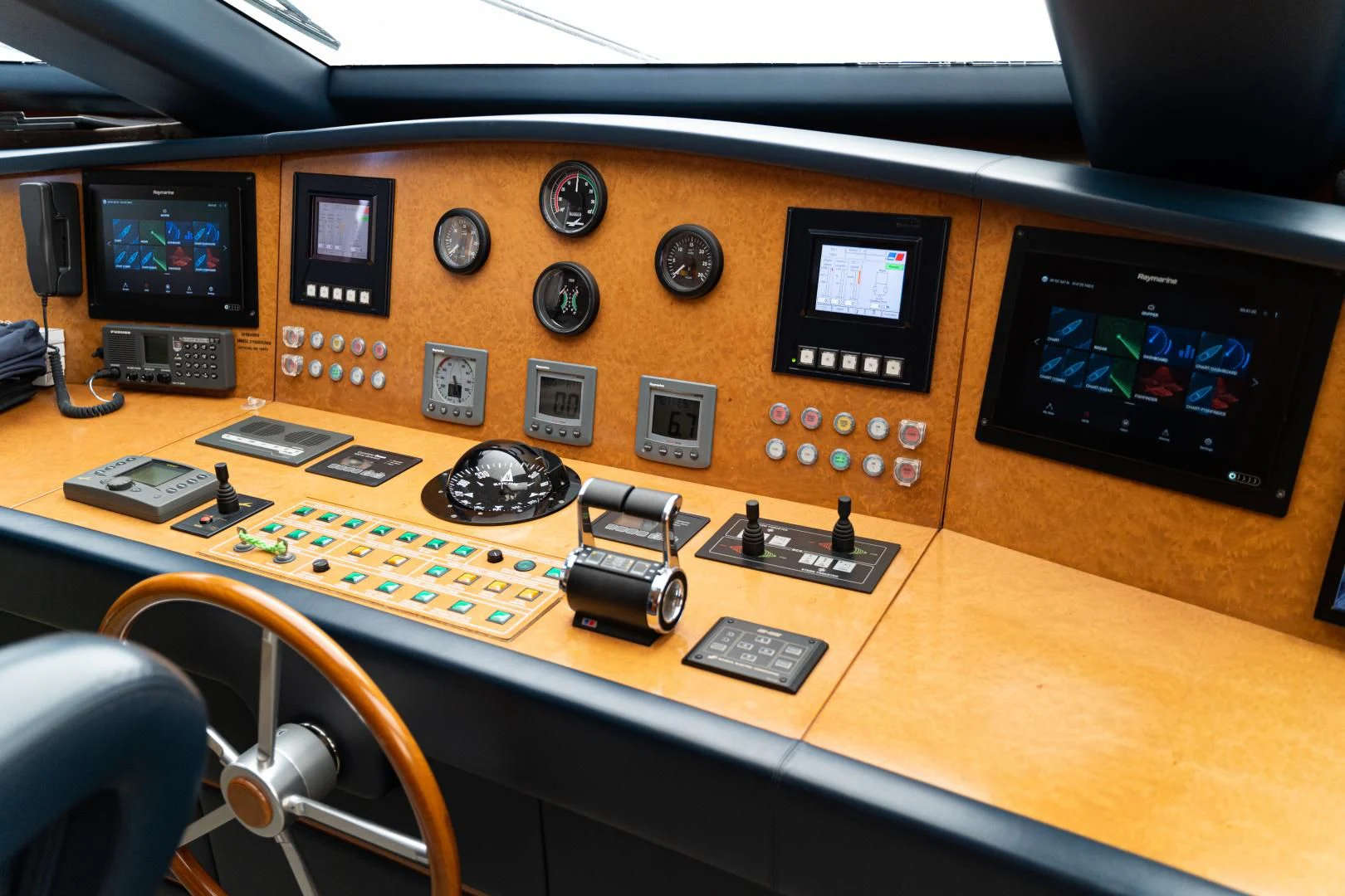 a desk with a computer and other electronic devices on it aboard ALPINN Yacht for Sale