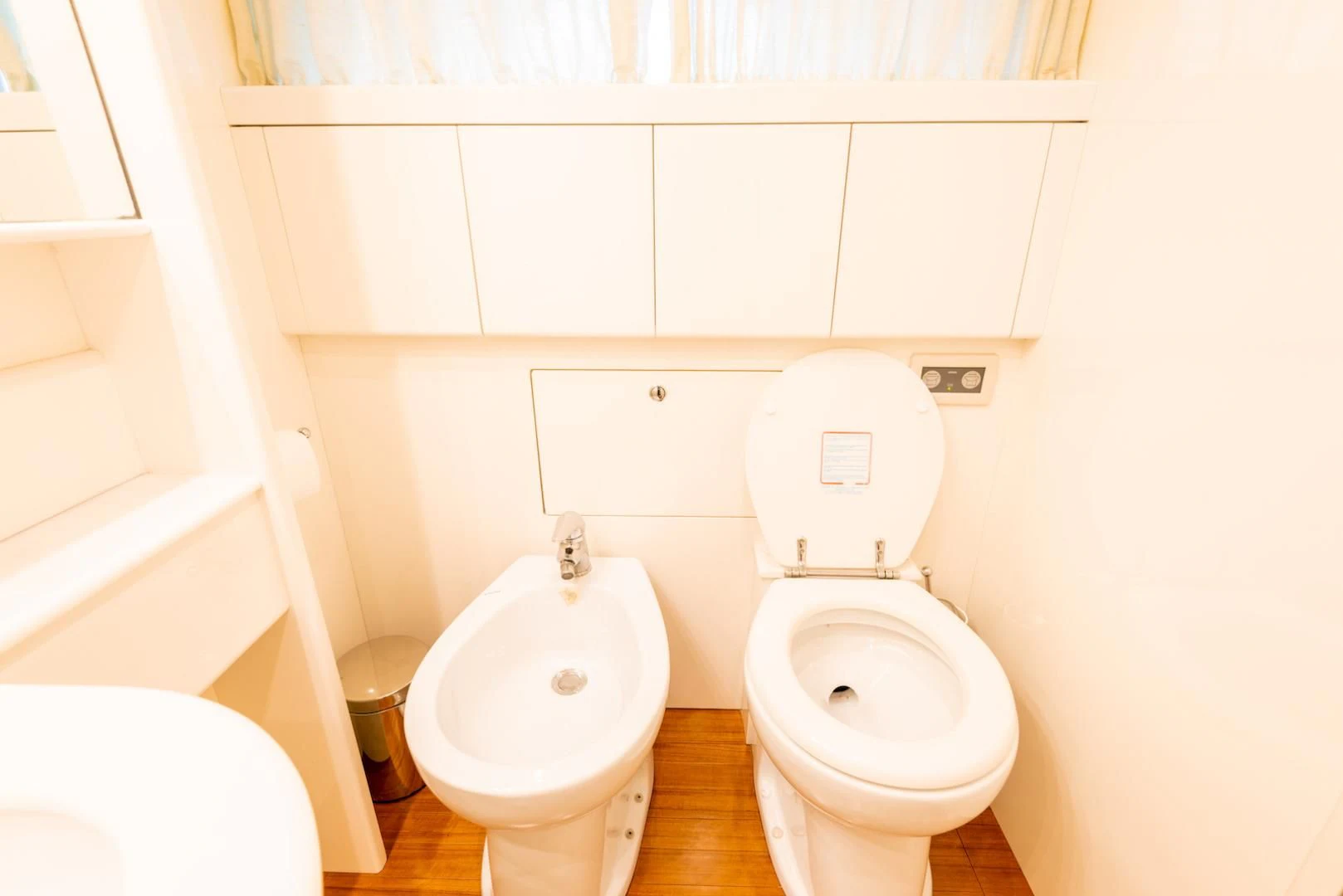 a toilet and a bidet in a bathroom aboard ALPINN Yacht for Sale