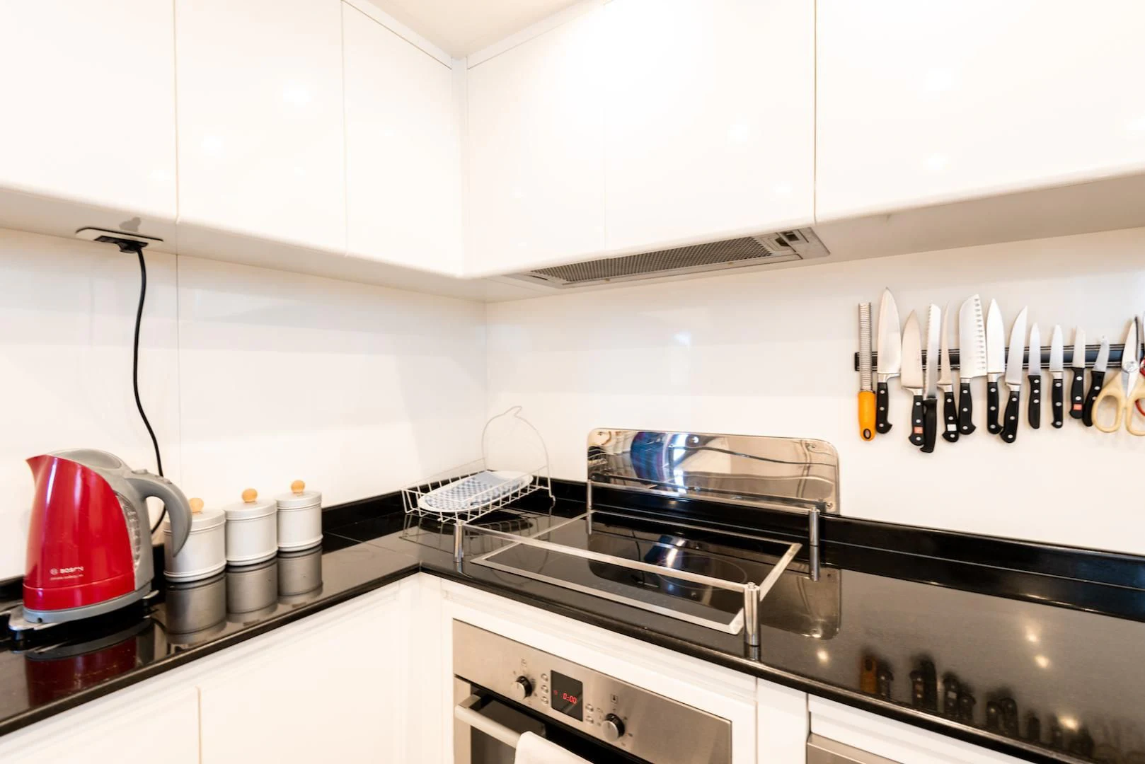 a kitchen with a red kettle on the stove aboard ALPINN Yacht for Sale