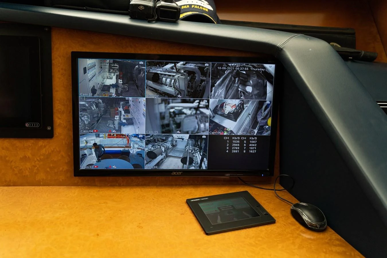 a computer monitor and a phone on a desk aboard ALPINN Yacht for Sale