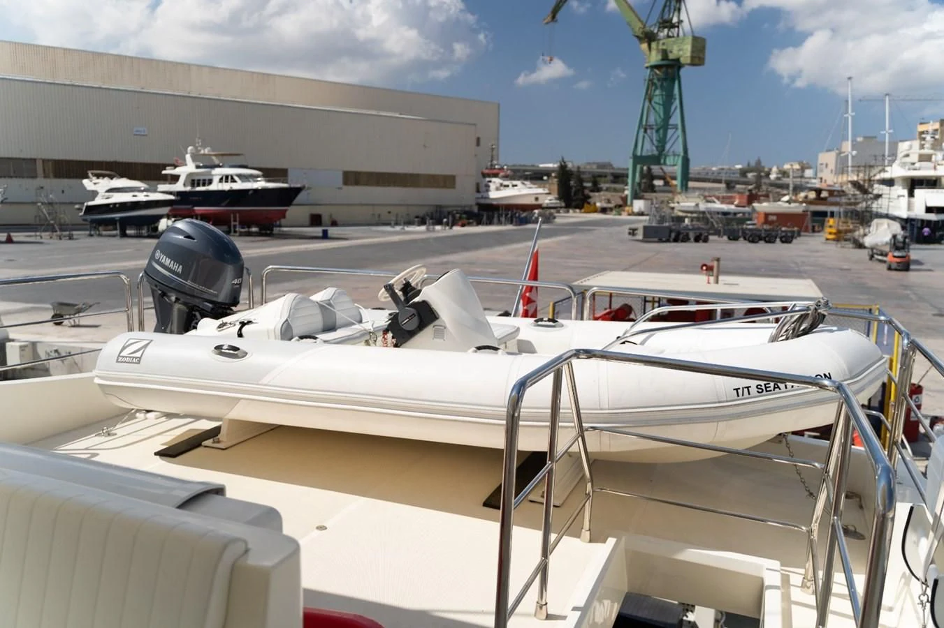 a white boat on a dock aboard ALPINN Yacht for Sale