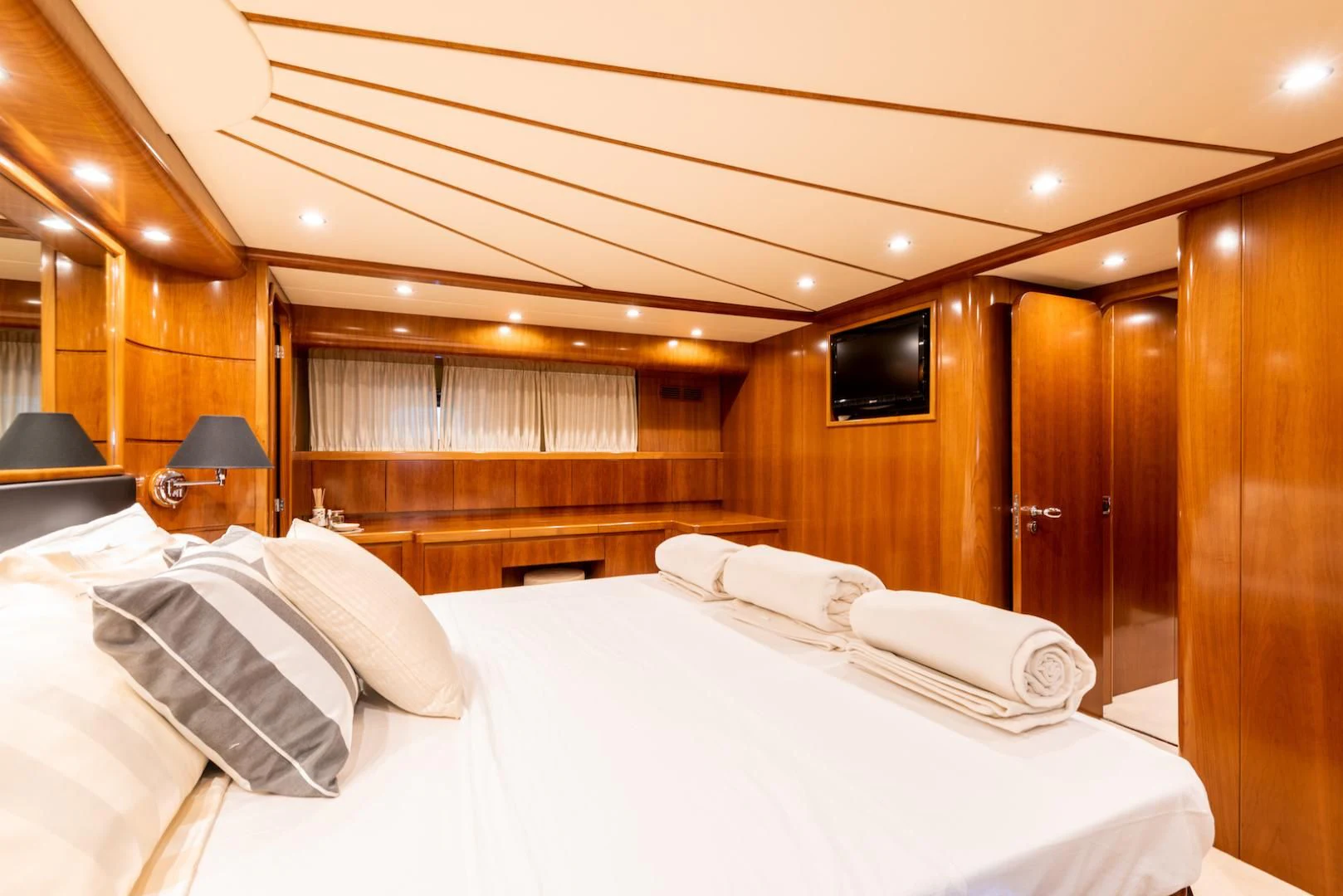 a room with a bed and a television aboard ALPINN Yacht for Sale