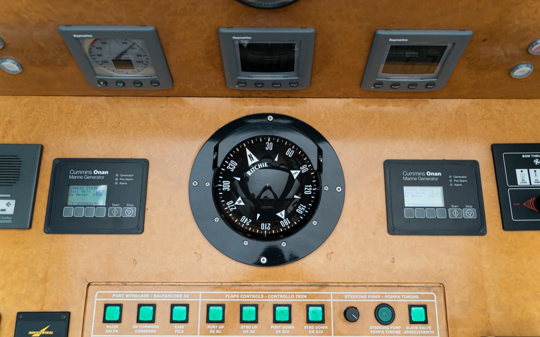 a black clock on a wooden surface aboard ALPINN Yacht for Sale