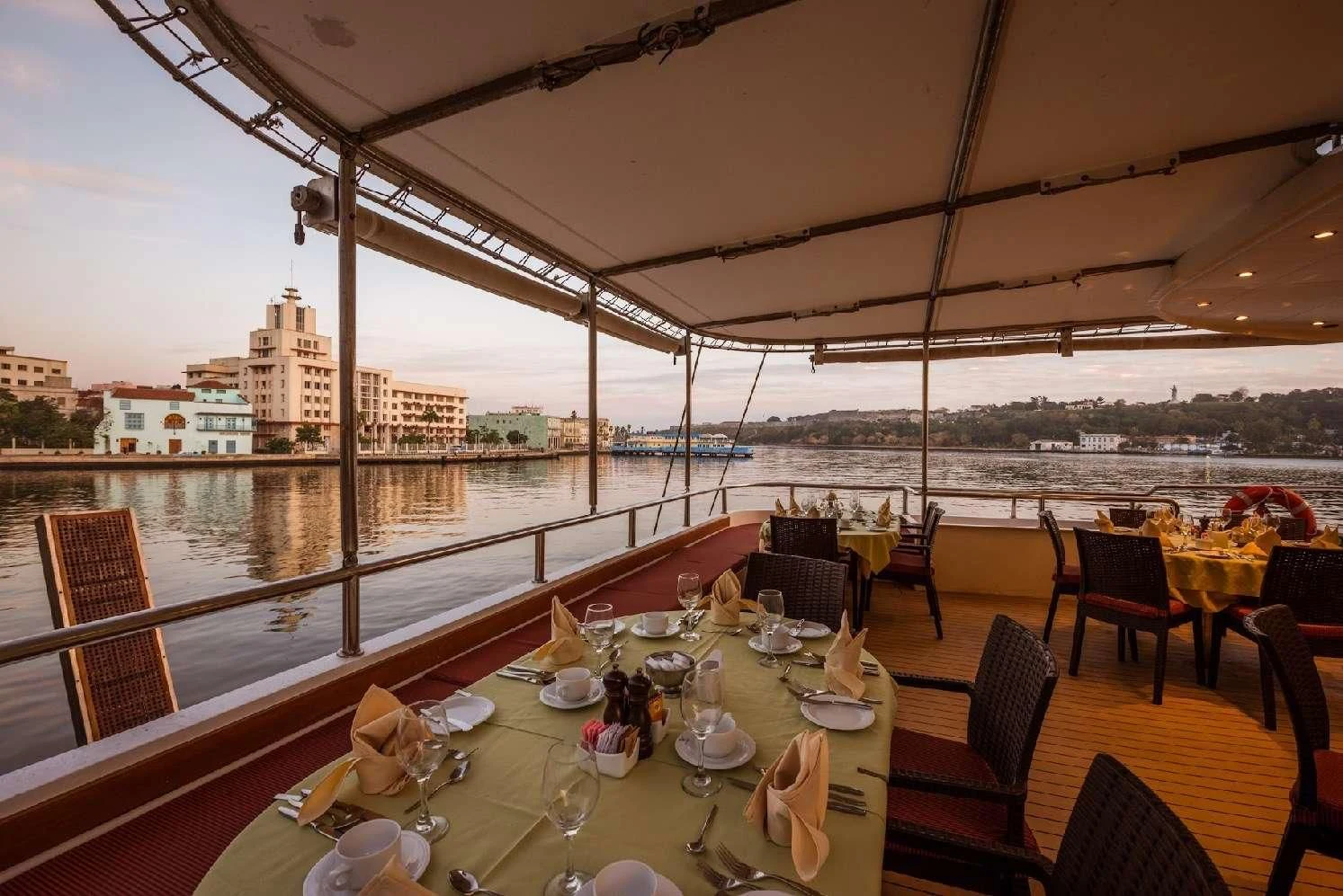 a table set for a meal on a balcony overlooking a city aboard PAN ORAMA II Yacht for Sale