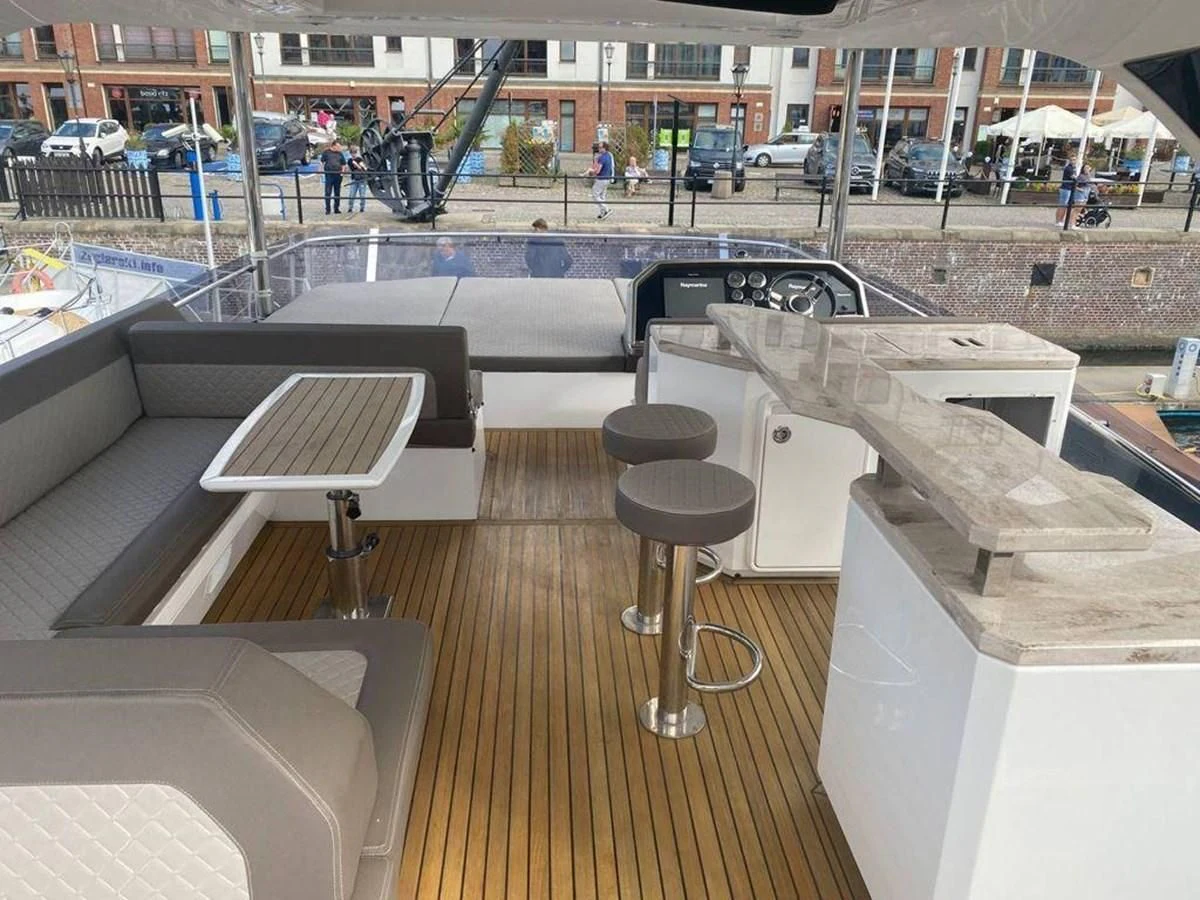 a room with a bench and a table aboard GALEON 640 Yacht for Sale