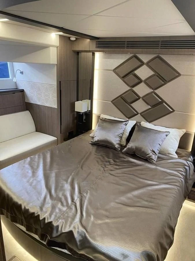 a bed with a white bed spread aboard GALEON 640 Yacht for Sale