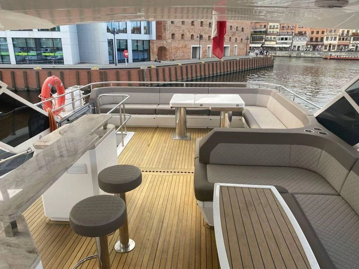 a room with a bench and a table and chairs aboard GALEON 640 Yacht for Sale