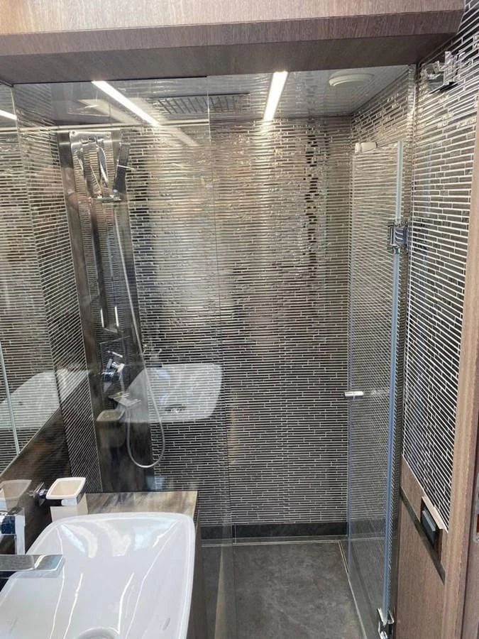a shower unit with a sink and mirror aboard GALEON 640 Yacht for Sale