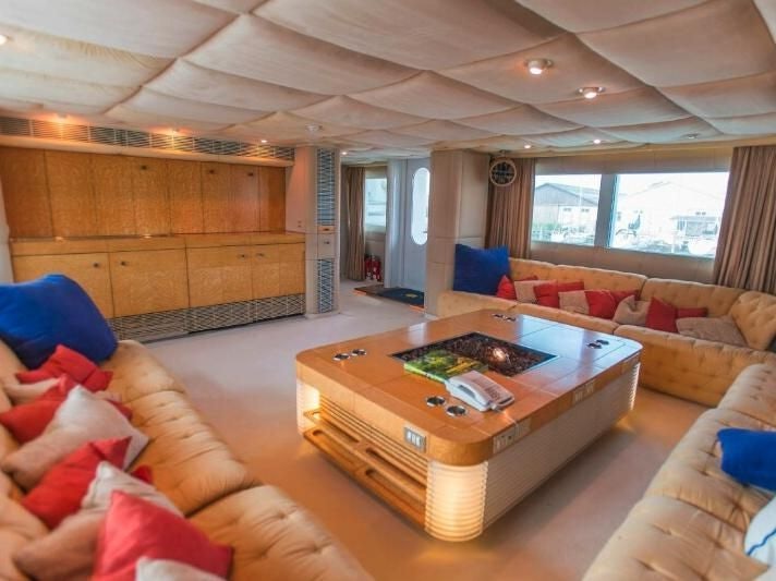 a living room with a table and couches aboard KORU Yacht for Charter