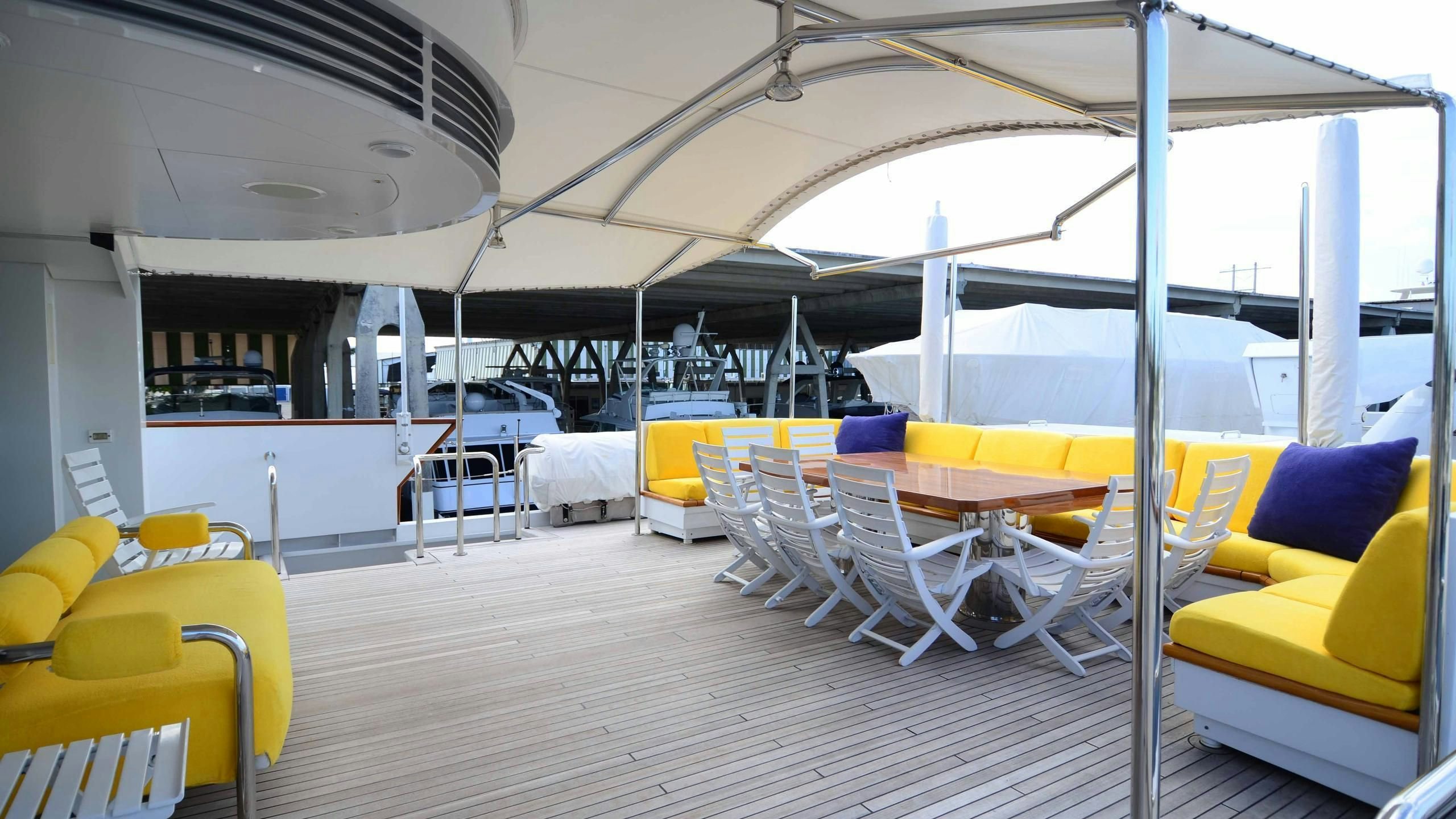 a room with tables and chairs aboard KORU Yacht for Charter