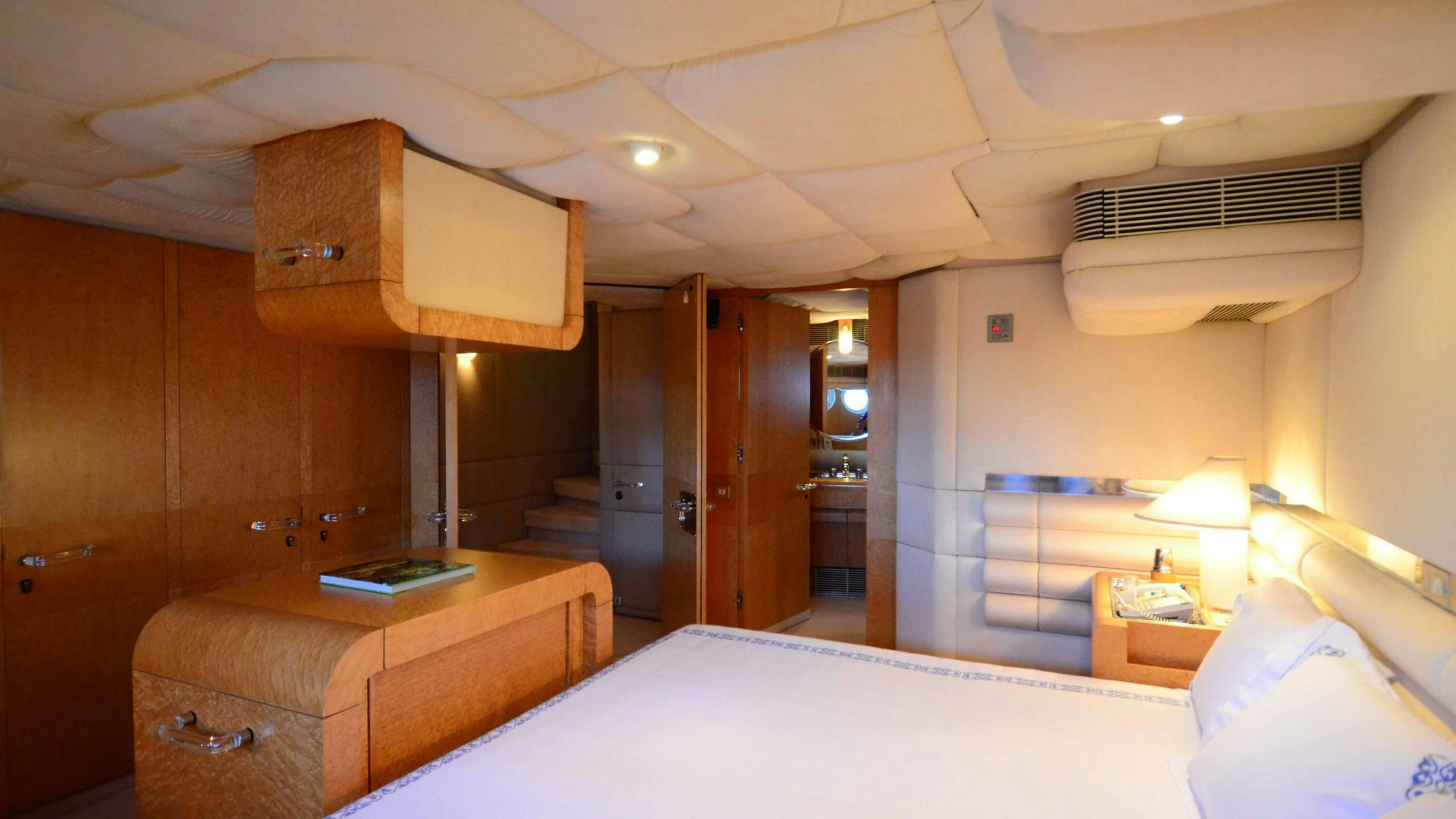 a room with a bed and a couch aboard KORU Yacht for Charter