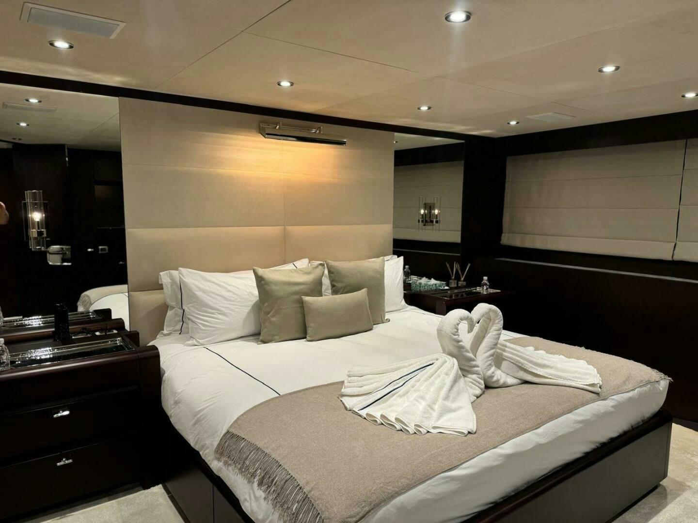 a bed with white sheets aboard KORU Yacht for Charter