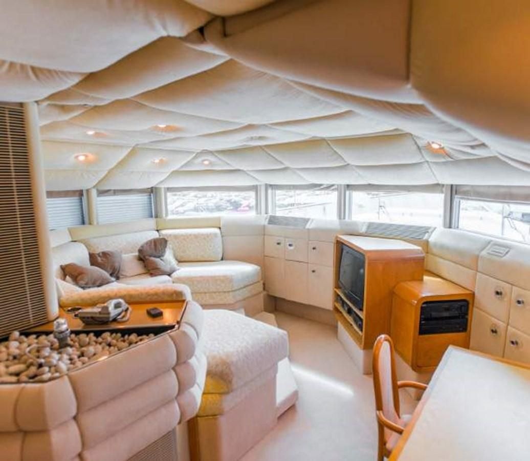 a room with a couch and a table aboard KORU Yacht for Charter