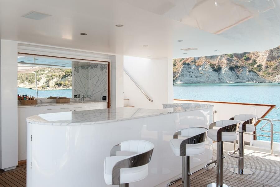 a large white kitchen with a large window aboard KORU Yacht for Charter
