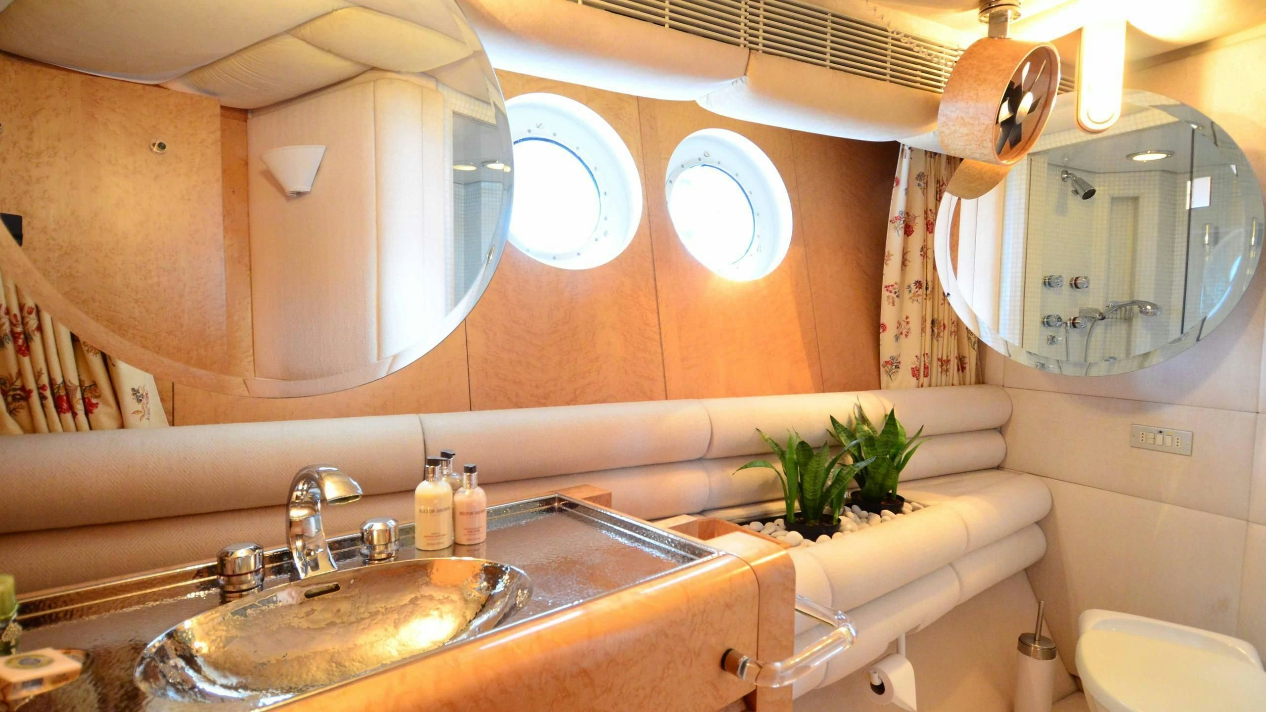 a bathroom with a sink and a mirror aboard KORU Yacht for Charter