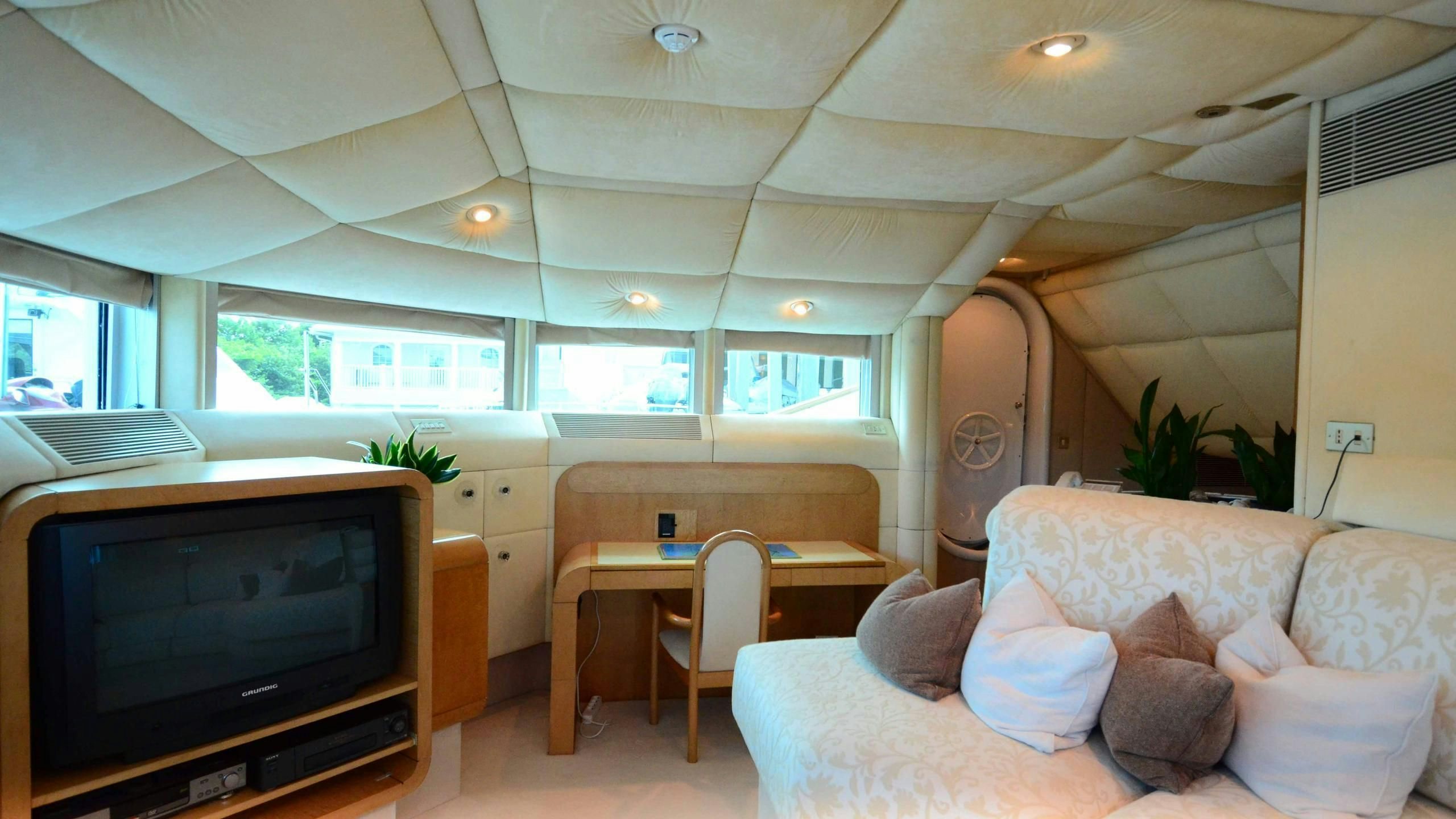 a living room with a tv and couches aboard KORU Yacht for Charter