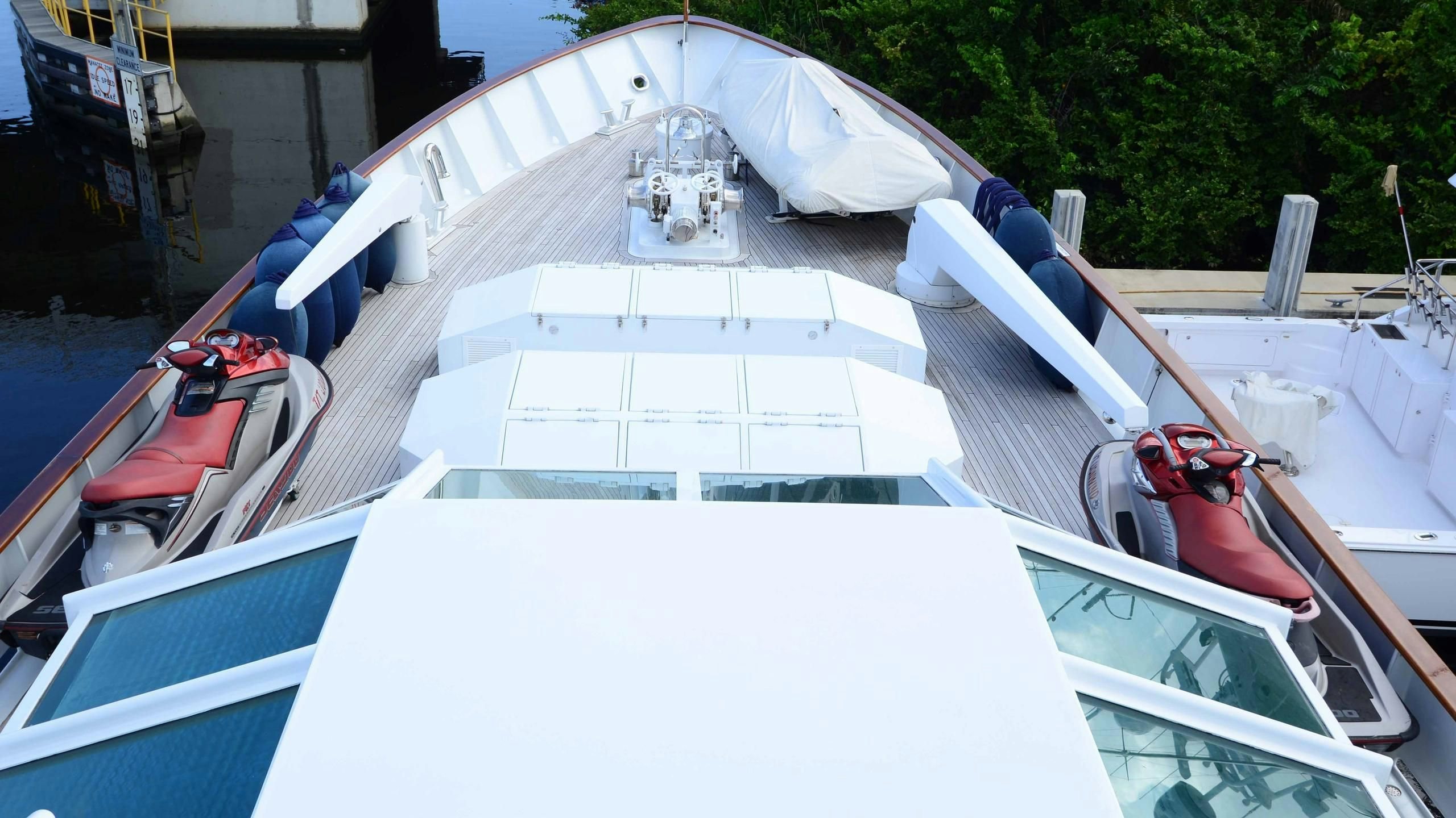 a white boat with a red and blue roof aboard KORU Yacht for Charter