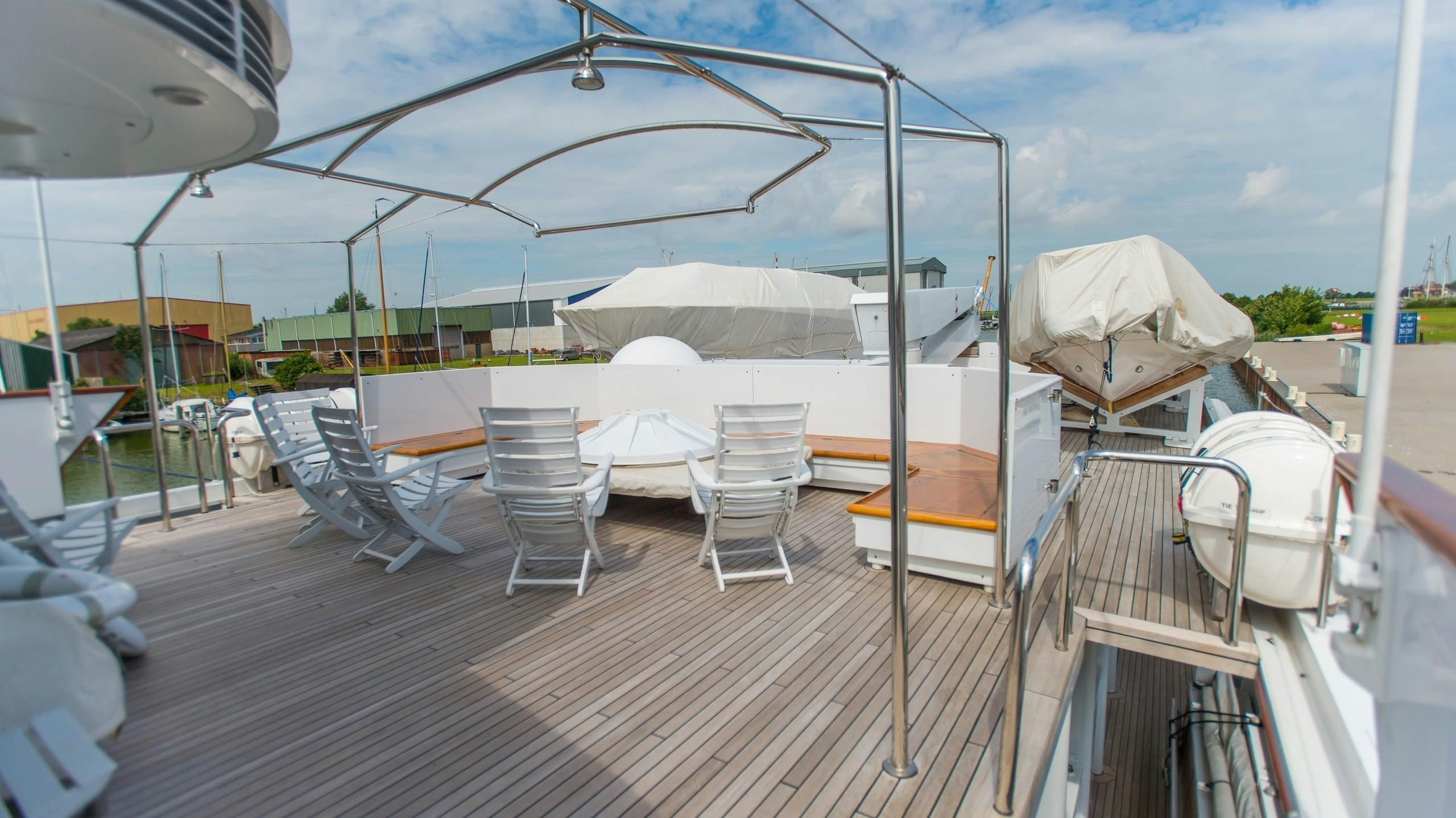 a deck with chairs and tables aboard KORU Yacht for Charter