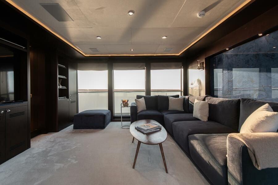 a living room with a couch and a table aboard KORU Yacht for Charter