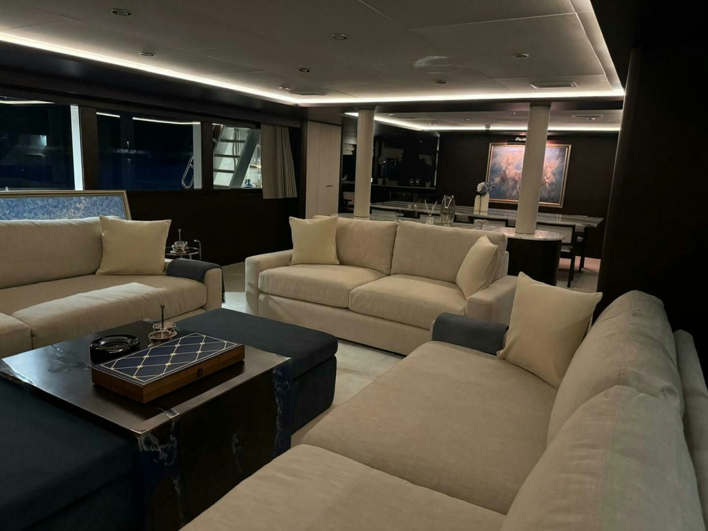 a living room with a couch and a coffee table aboard KORU Yacht for Charter