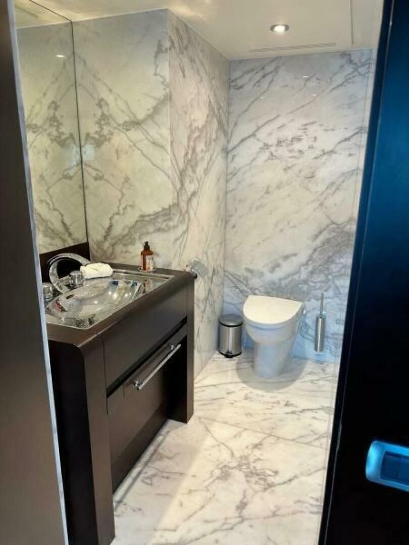 a bathroom with a sink and a toilet aboard KORU Yacht for Charter