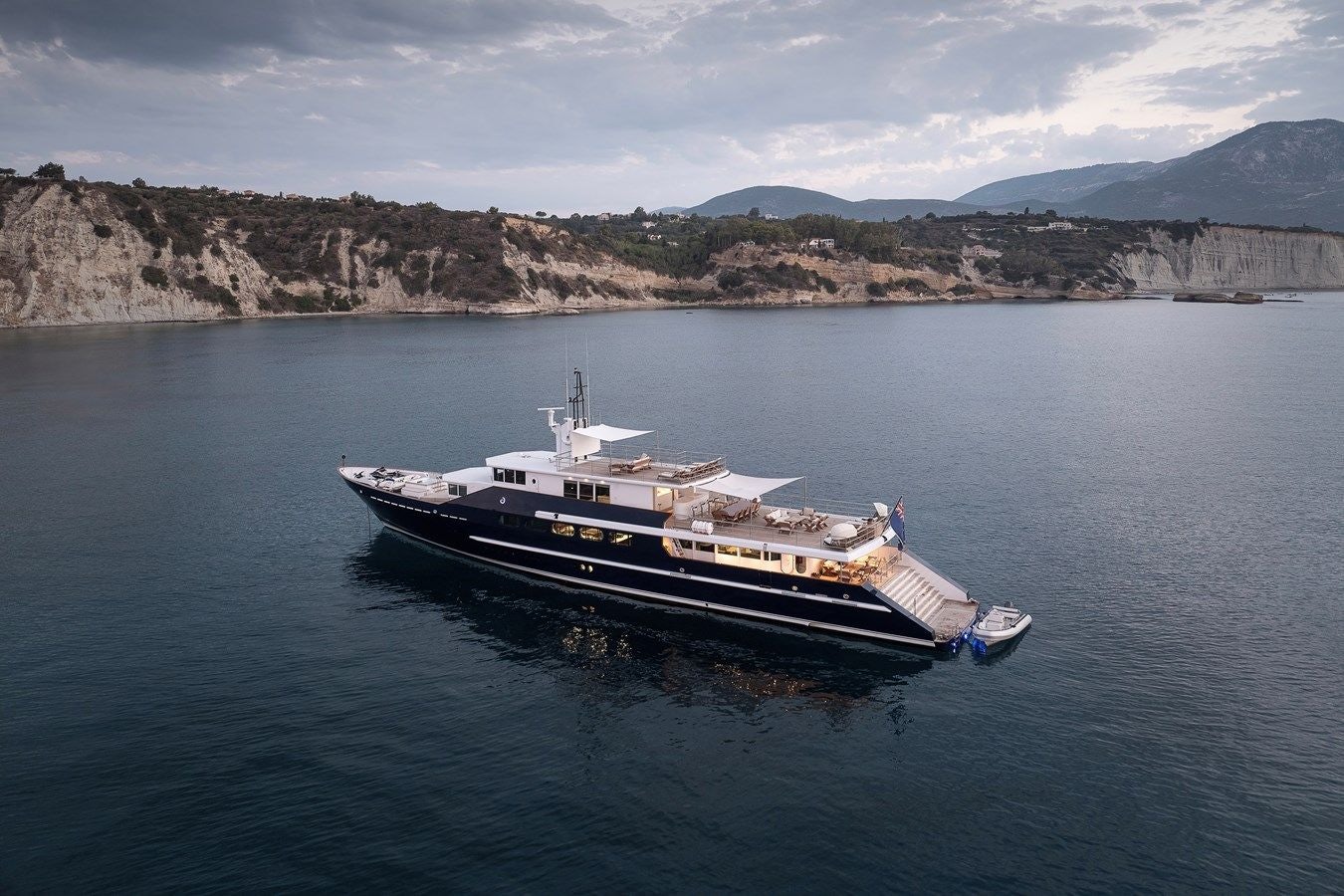 a boat in the water with Lake Mead in the background aboard KORU Yacht for Charter