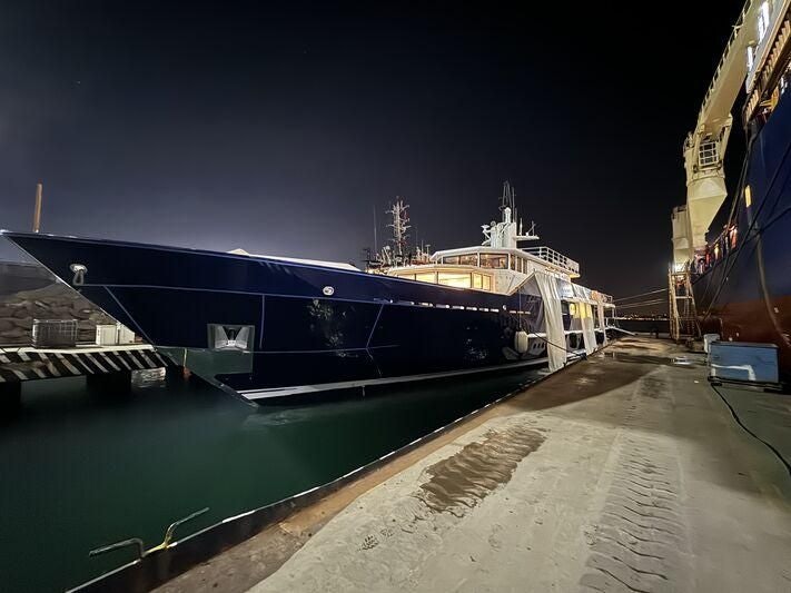 a large ship docked at night aboard KORU Yacht for Charter