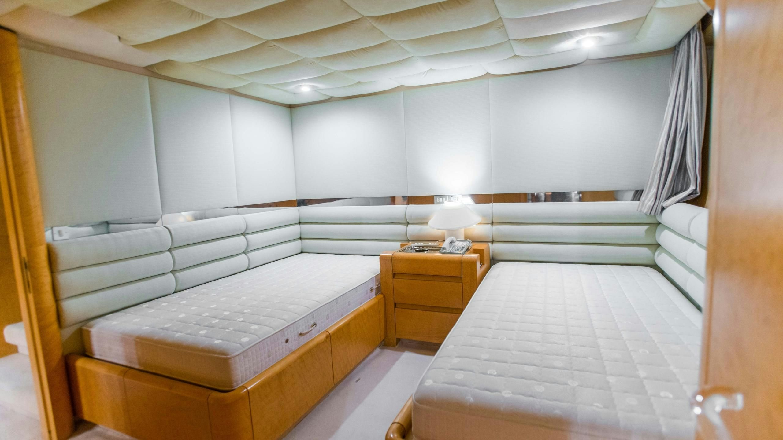 a room with two beds aboard KORU Yacht for Charter