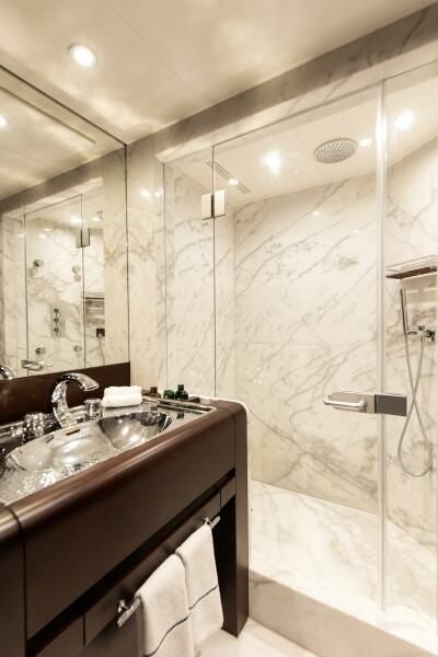 a bathroom with a sink and a mirror aboard KORU Yacht for Charter