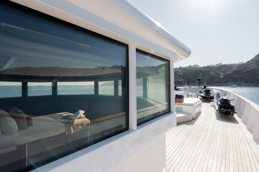 a deck with a view of the ocean and boats aboard KORU Yacht for Charter