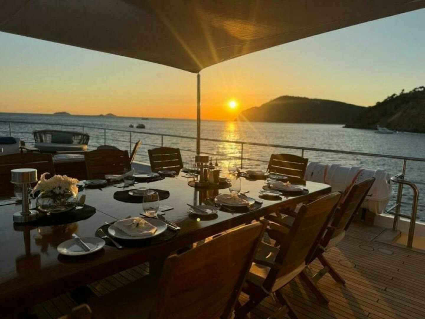 a table with plates and food on it aboard KORU Yacht for Charter