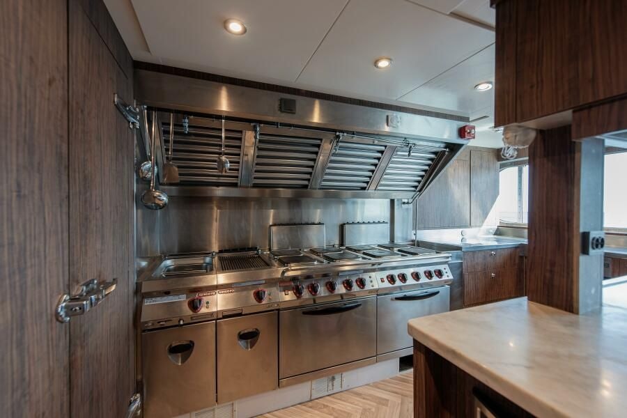 a kitchen with a stove and a sink aboard KORU Yacht for Charter