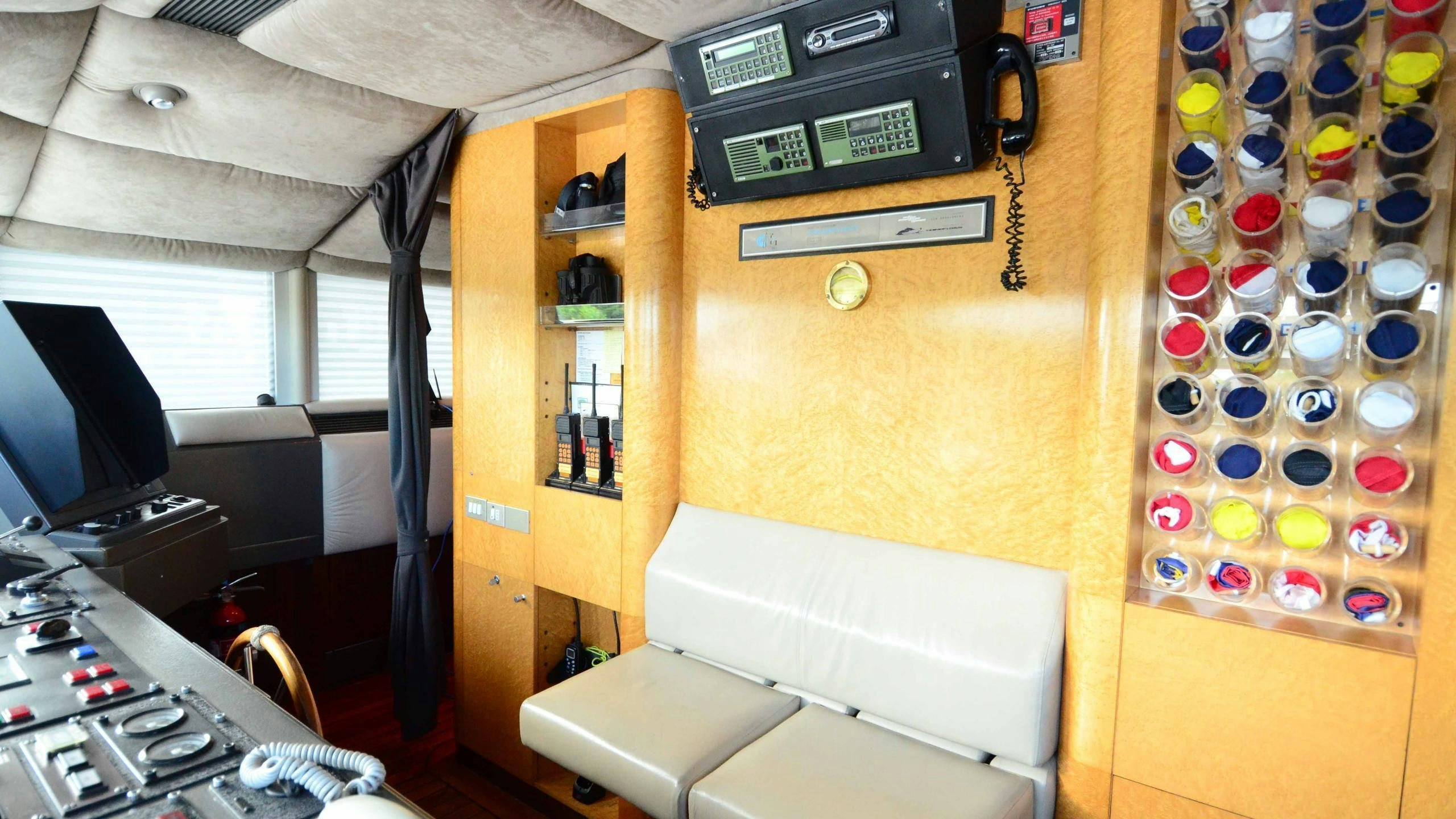 a room with a bed and desk aboard KORU Yacht for Charter