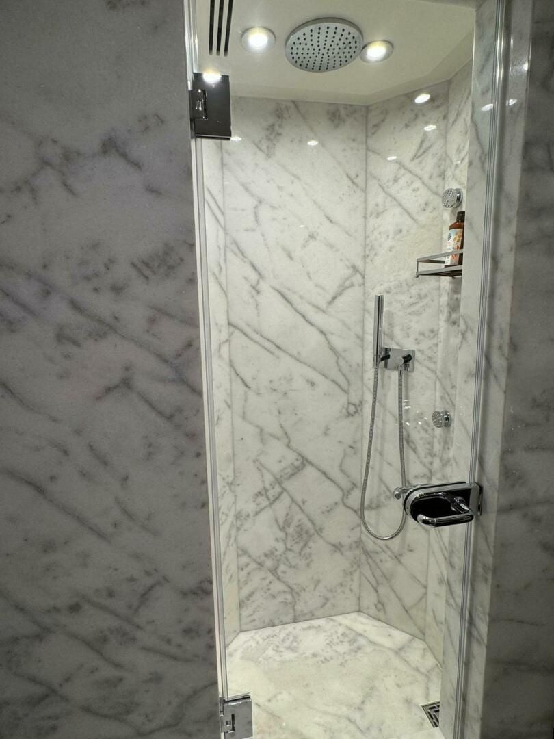 a shower with a glass door aboard KORU Yacht for Charter