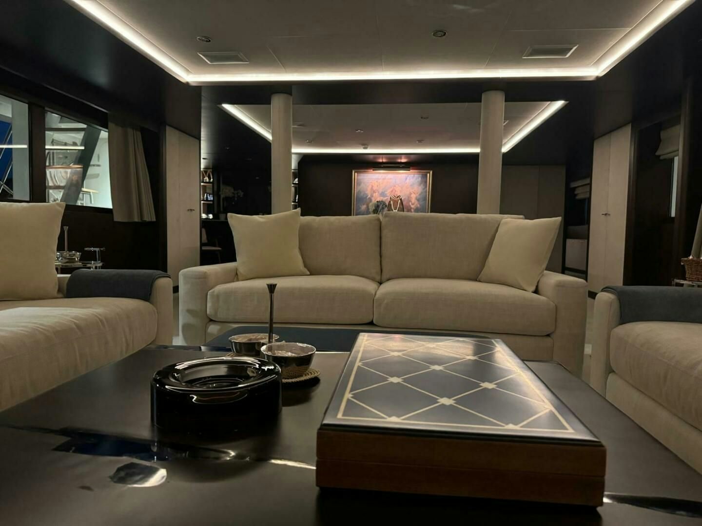 a living room with a table and couches aboard KORU Yacht for Charter