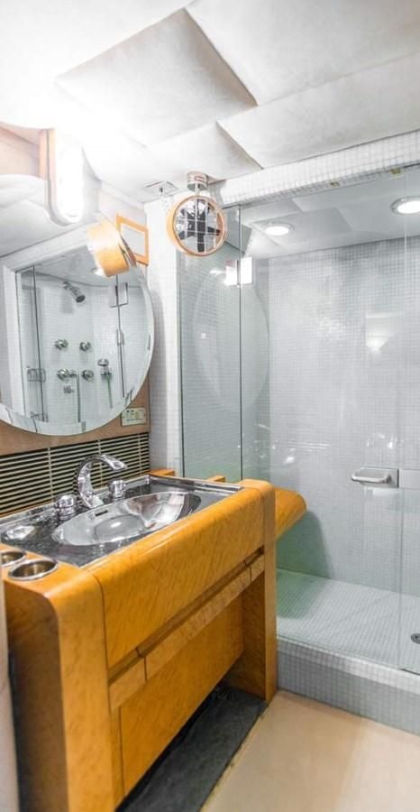 a bathroom with a sink and a mirror aboard KORU Yacht for Charter