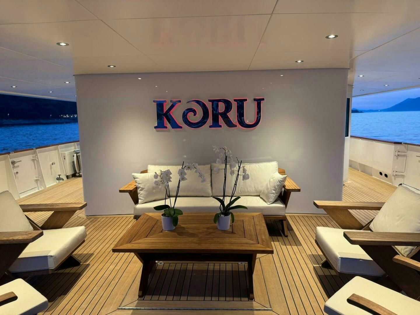 a room with a couch and a table aboard KORU Yacht for Charter
