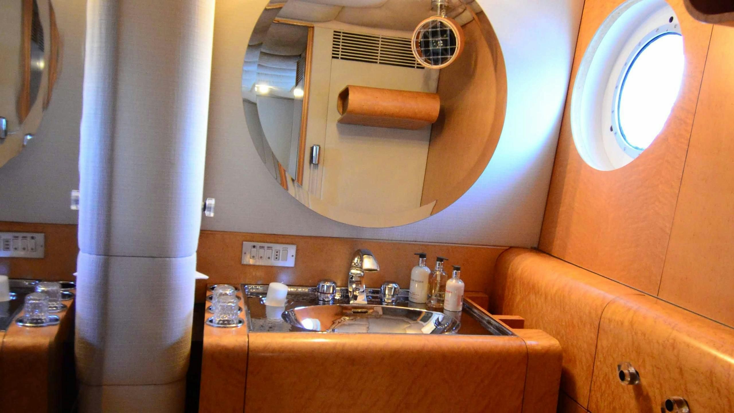 a bathroom with a sink and a mirror aboard KORU Yacht for Charter